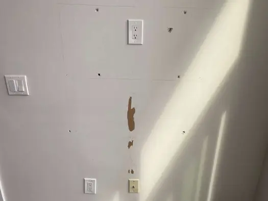 A residential unit requiring move-out repairs and patching before a new tenant arrives